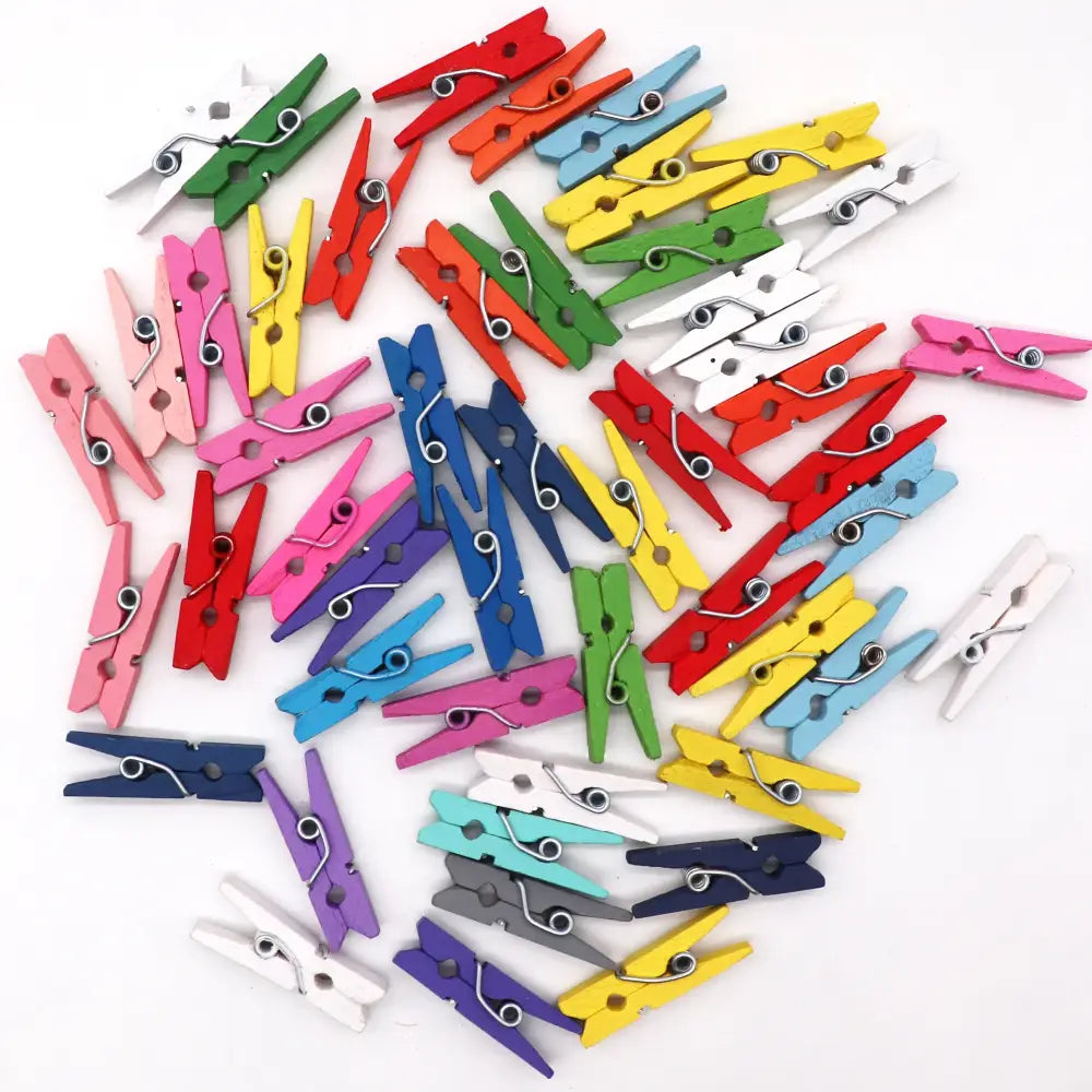 A collection of assorted colorful mini wooden clips with metal springs for bedroom photo decor and organization