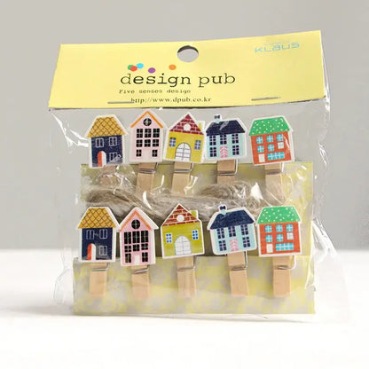 Assorted colorful mini wooden clips shaped like houses with painted roofs and windows in clear plastic bag for decor