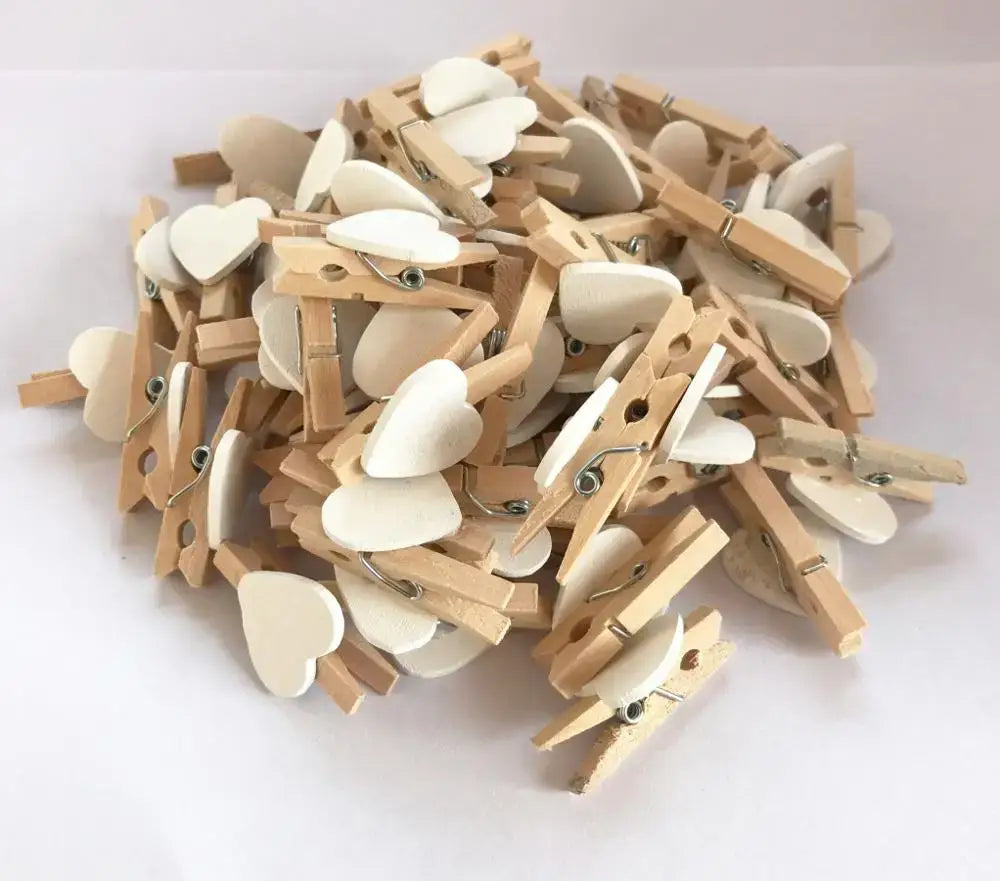 A pile of light wood heart-shaped mini wooden clips with white smooth-finished clips for bedroom photo decor