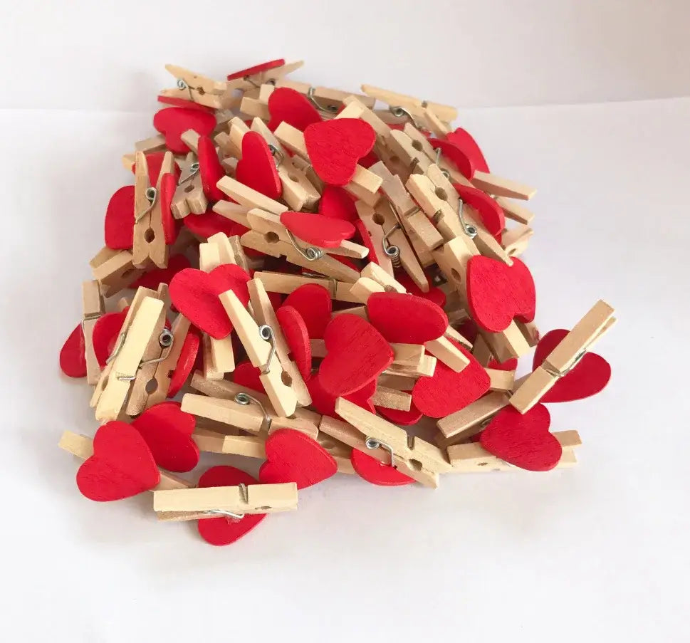 A pile of wooden clips with red heart-shaped felt attachments for bedroom photo decor mini wooden clips