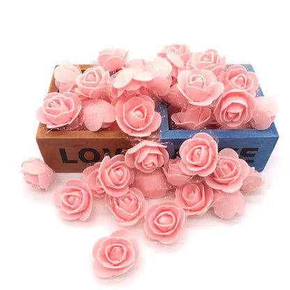 Pink handmade foam rose flower heads scattered in and around wooden boxes for wedding decor by decorbites handmade foam