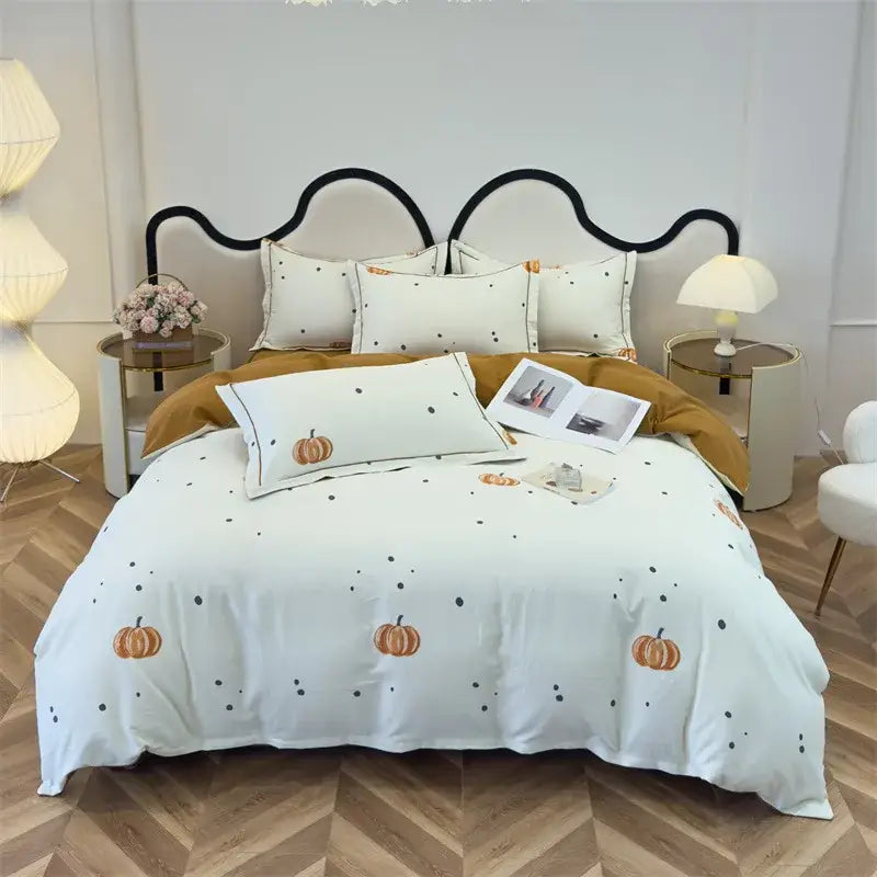 White pumpkin-themed duvet cover set with embroidered orange pumpkins and black dots on cream brushed cotton fabric