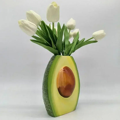Avocado ceramic vase with glossy green exterior and brown pit holding white tulips for home decor and living room craft pot