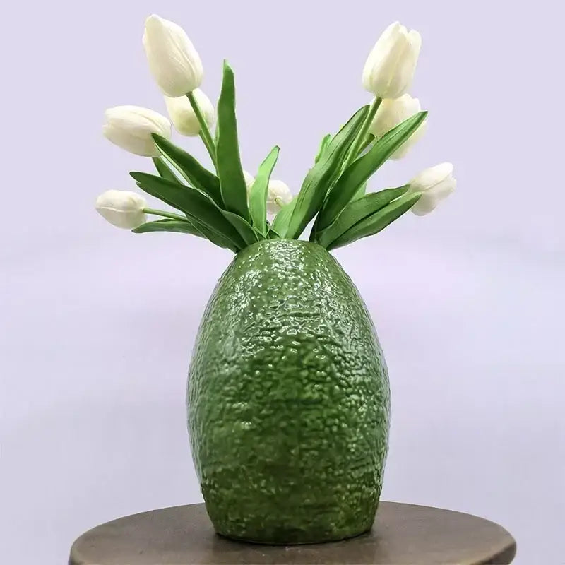 A textured deep green avocado ceramic vase with white tulips for green and yellow living room home decor