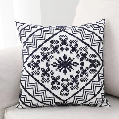 Black and white aztec embroidery canvas cushion cover with geometric zigzag borders and cross-stitch snowflake design