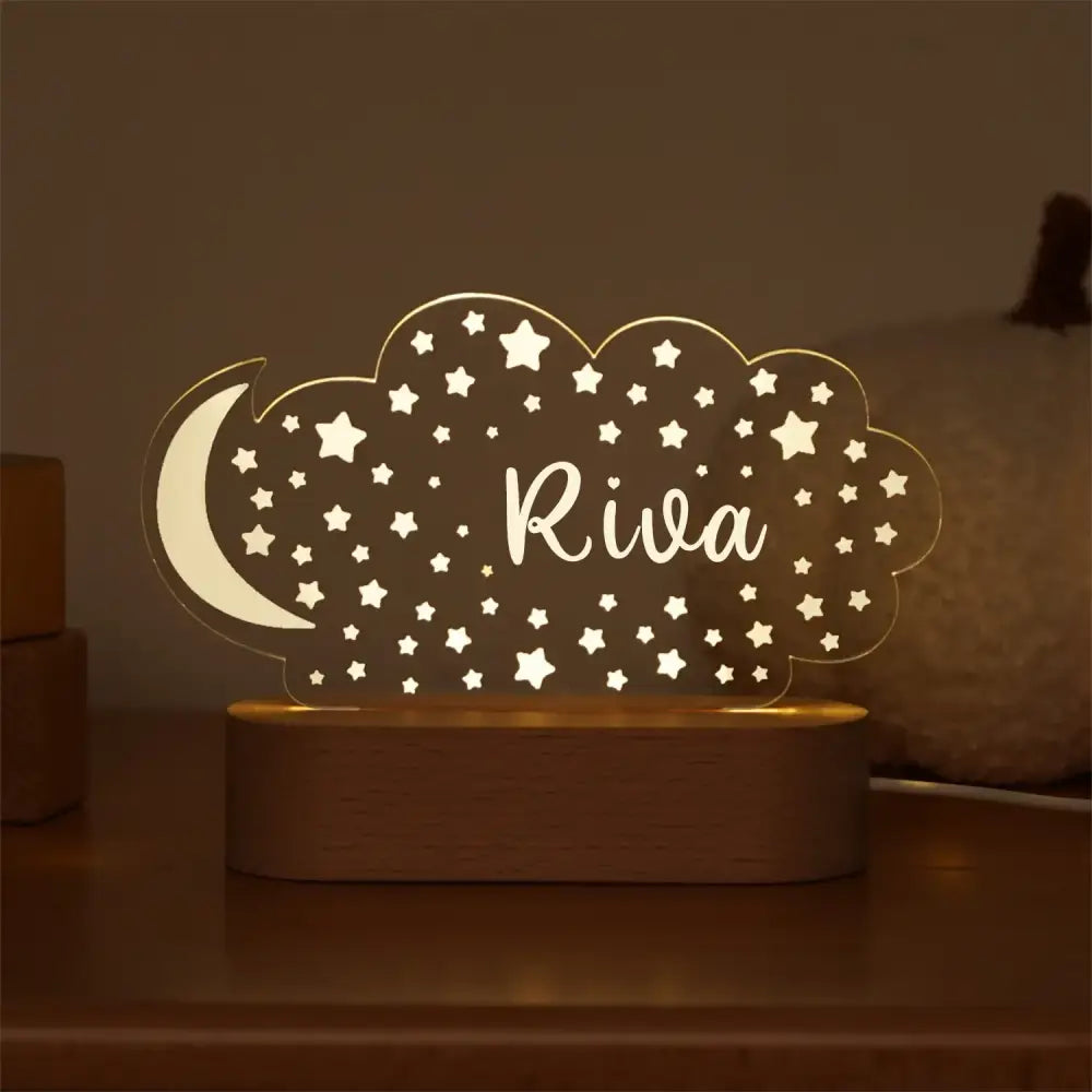 A warm-lit personalized cloud-shaped usb night light for baby kids with crescent moon star pattern and riva engraving