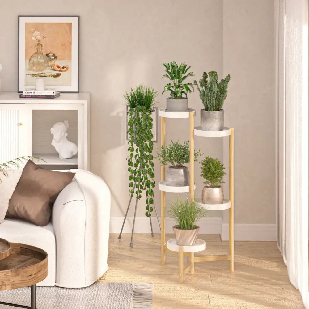 Modern bamboo plant stand with five white circular shelves and slender legs holding green plants in concrete pots