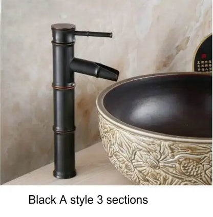 Black a-style basin mixer tap with bamboo-inspired antique brass and black design for bathroom basin use