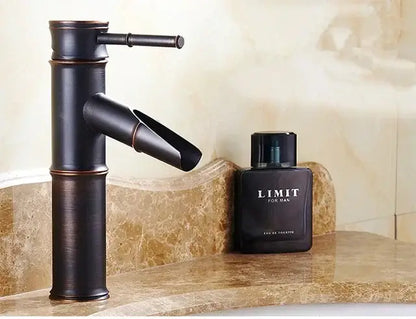 Bronze bamboo-style high arch mixer faucet with matte finish and modern waterfall design for bathroom use