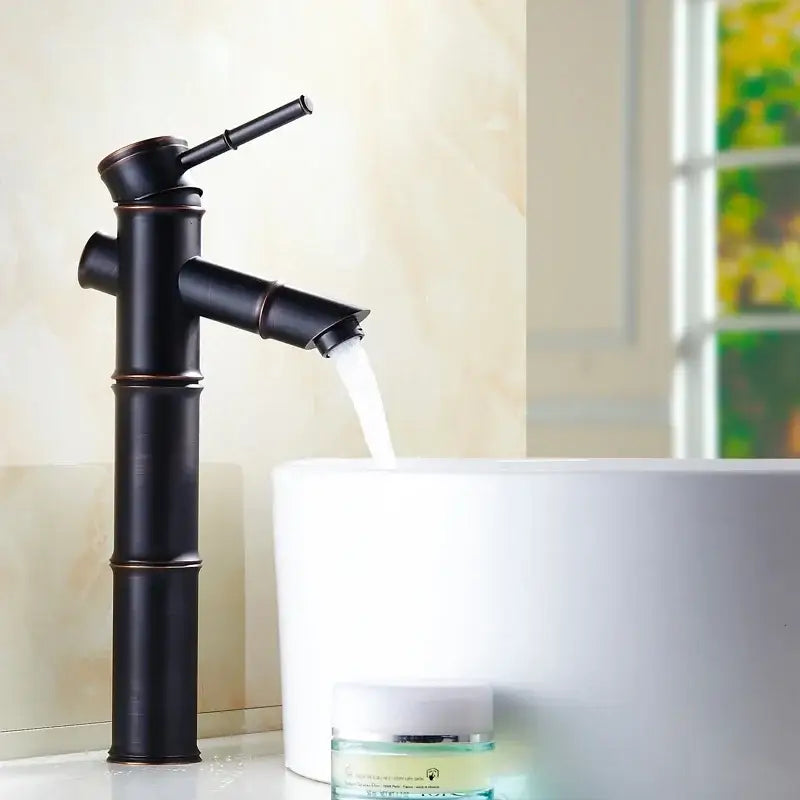Black bamboo style high arch mixer faucet with matte finish and copper accents for bathroom waterfall use