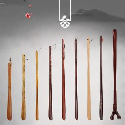 Set of eight wooden shoe shapers with bamboo pattern long handle in varying tones and decorative finishes for shoe lifter use