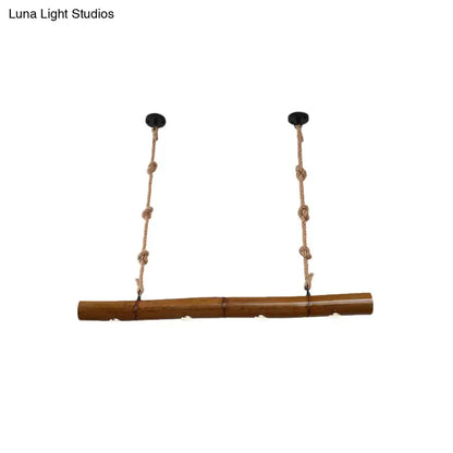 Decorbites™ bamboo tube island pendant light with yellow and brown bamboo, two braided rope suspensions, and black mounts