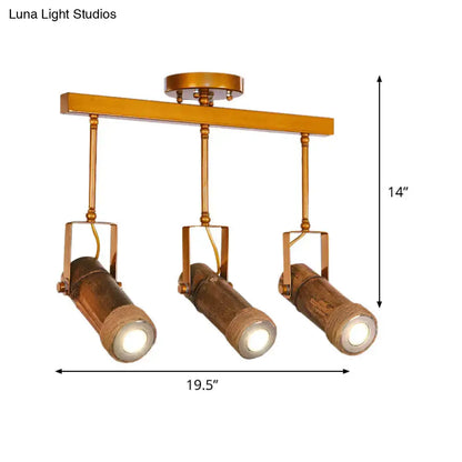 Gold-toned industrial ceiling fixture with three bamboo tube spotlight heads and hemp rope suspension for led light use