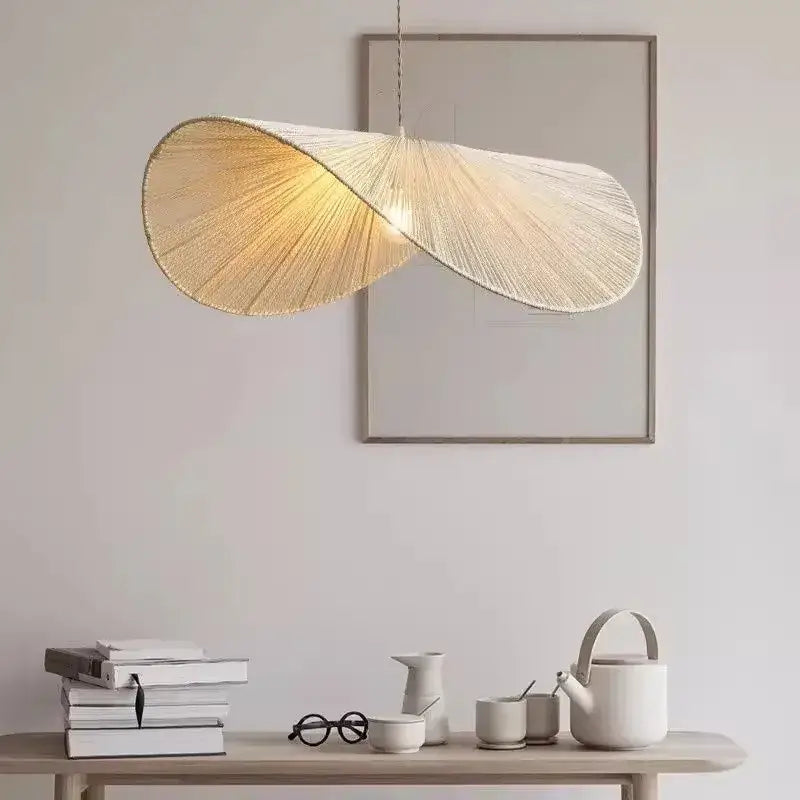Cream-colored bamboo wabi sabi pendant light with flowing twisted rattan design for dining room illumination