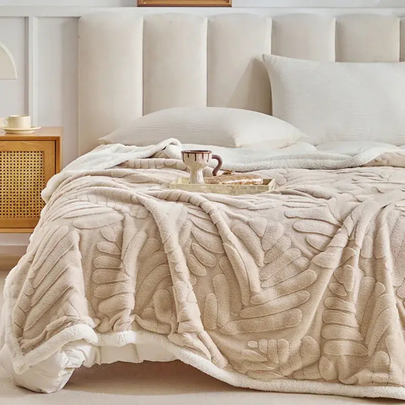 Beige banana leaf jacquard faux rabbit fur throw blanket with raised leaf pattern and soft white fleece border