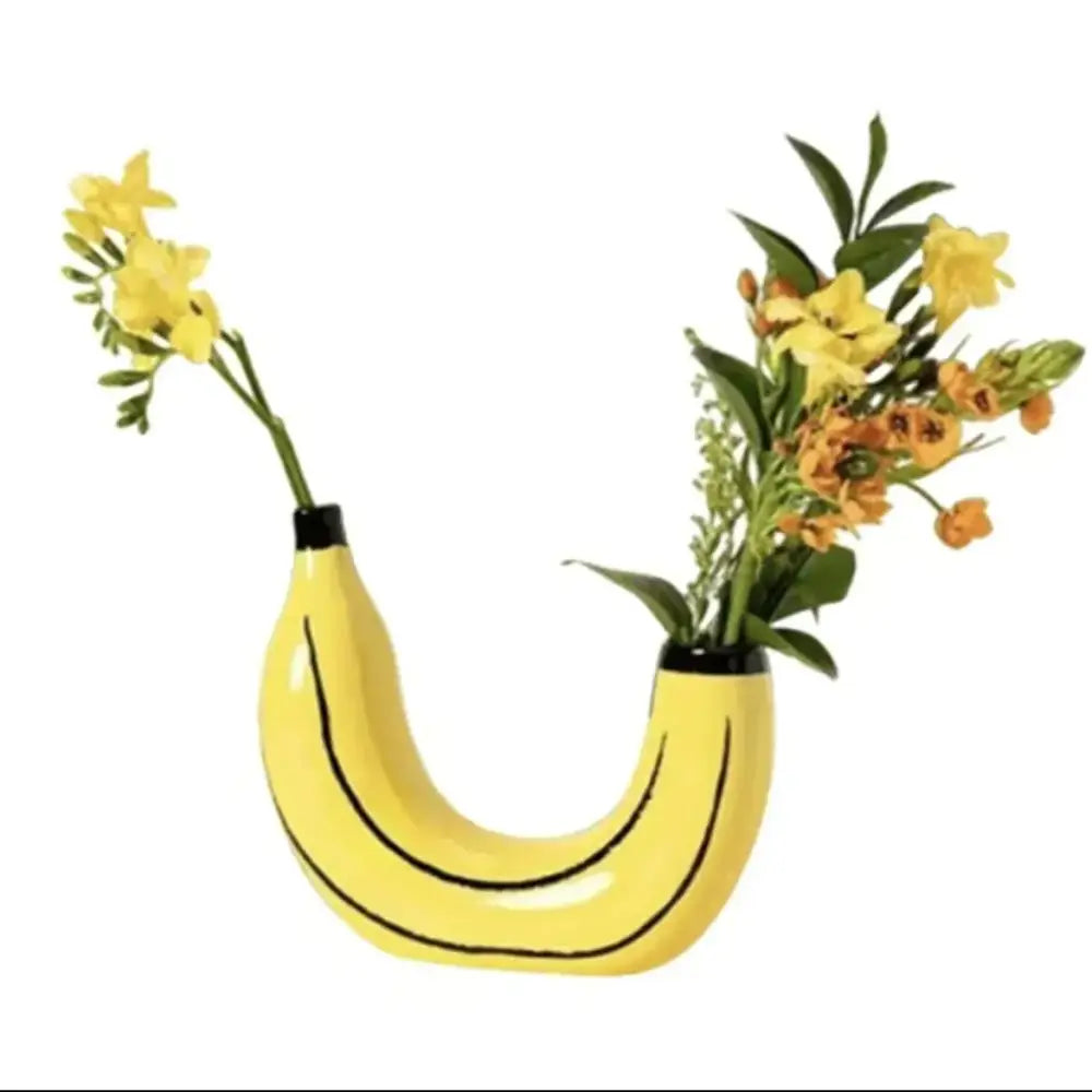 Yellow banana shape resin flower vase with black curved lines and glossy finish for decorative use