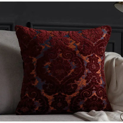 A plush burgundy velvet cushion cover with gold and blue damask cut velvet pattern for decorbites living room decor