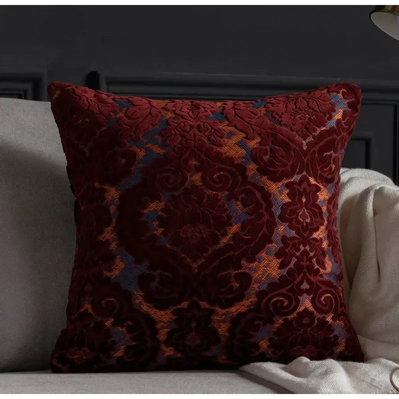 A plush burgundy velvet cushion cover with gold and blue damask cut velvet pattern for decorbites living room decor