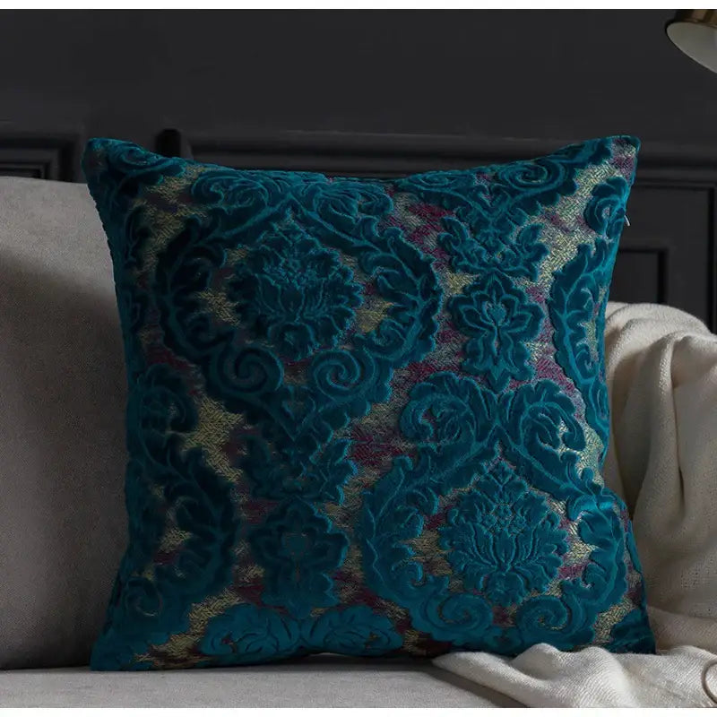 Teal velvet cushion with intricate gold and burgundy embroidery featured in decorbites damask cut velvet cushion covers