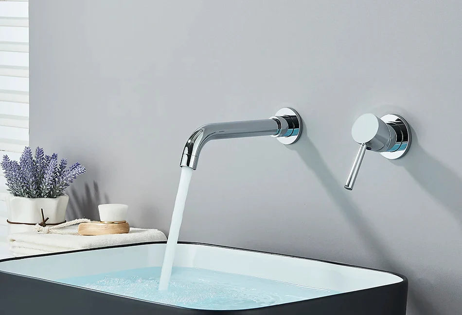 Modern chrome finished basin faucet wall mounted with sleek curved spout and separate handle for hot water control