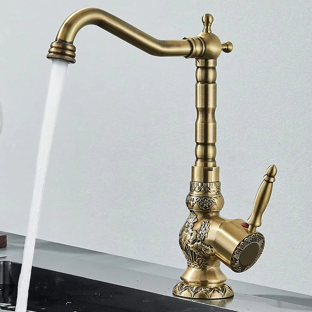 Antique brass single handle basin faucet with ornate floral engraving and curved spout for single hole sink