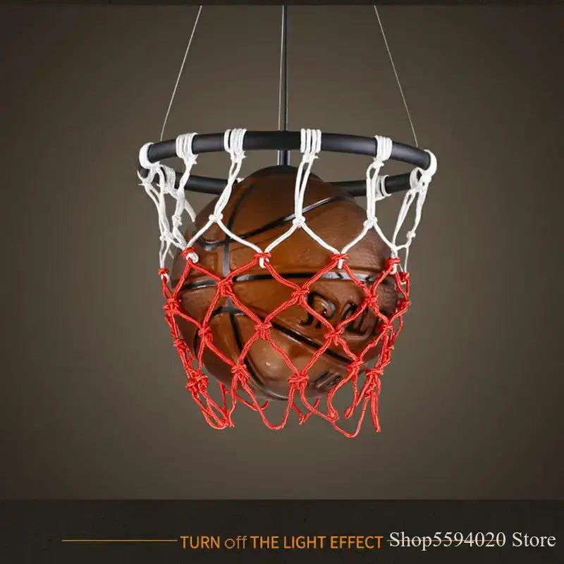 A brown basketball pendant light suspended in a black hoop with white and red netting decorbites basketball pendant