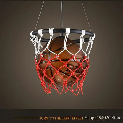 A brown basketball pendant light suspended in a black hoop with white and red netting decorbites basketball pendant