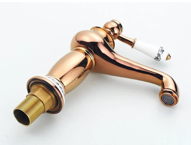 Bathroom faucet antique bronze finish with rose gold finish and white ceramic handle featuring ornate silver design