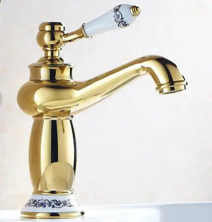 Bathroom faucet with gold-finished bronze finish and white ceramic handle featuring blue floral patterns