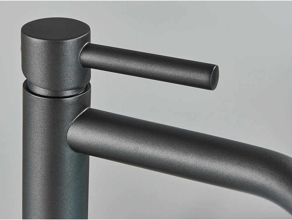 Matte black bathroom faucet with sleek minimalist design and cylindrical handle for modern mixer tap use