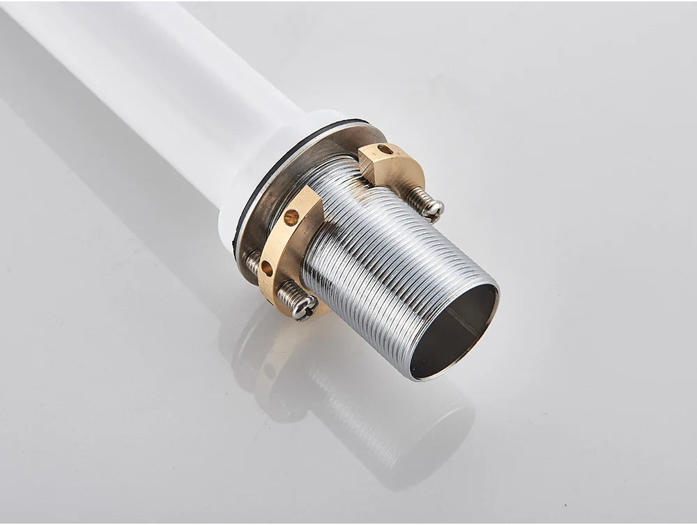 Silver threaded metal pipe connector with brass fittings attached to white plastic pipe for bathroom faucet brushed gold mixer tap