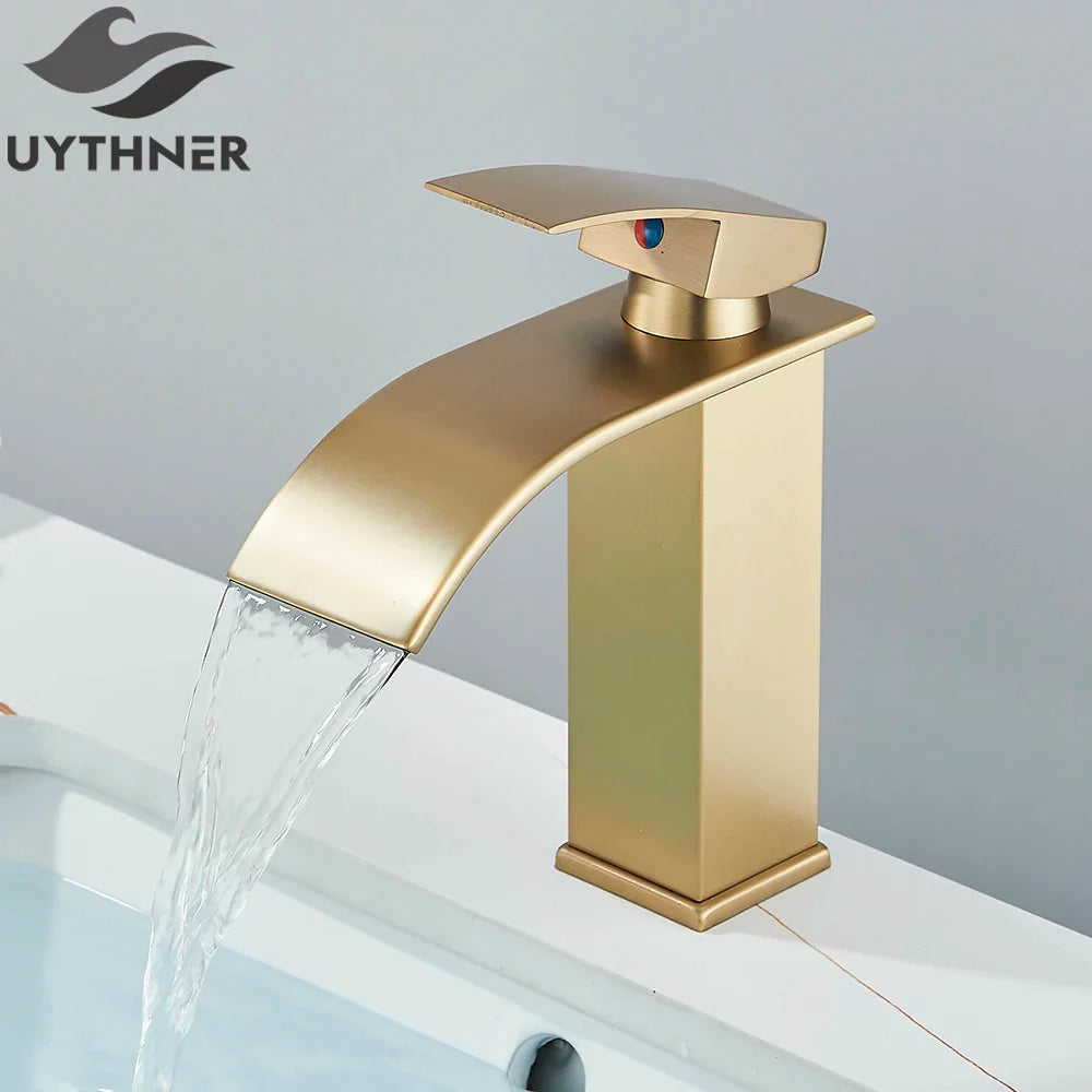 Gold-colored bathroom sink faucet brass deck mount with brushed metallic finish stainless steel modern waterfall design