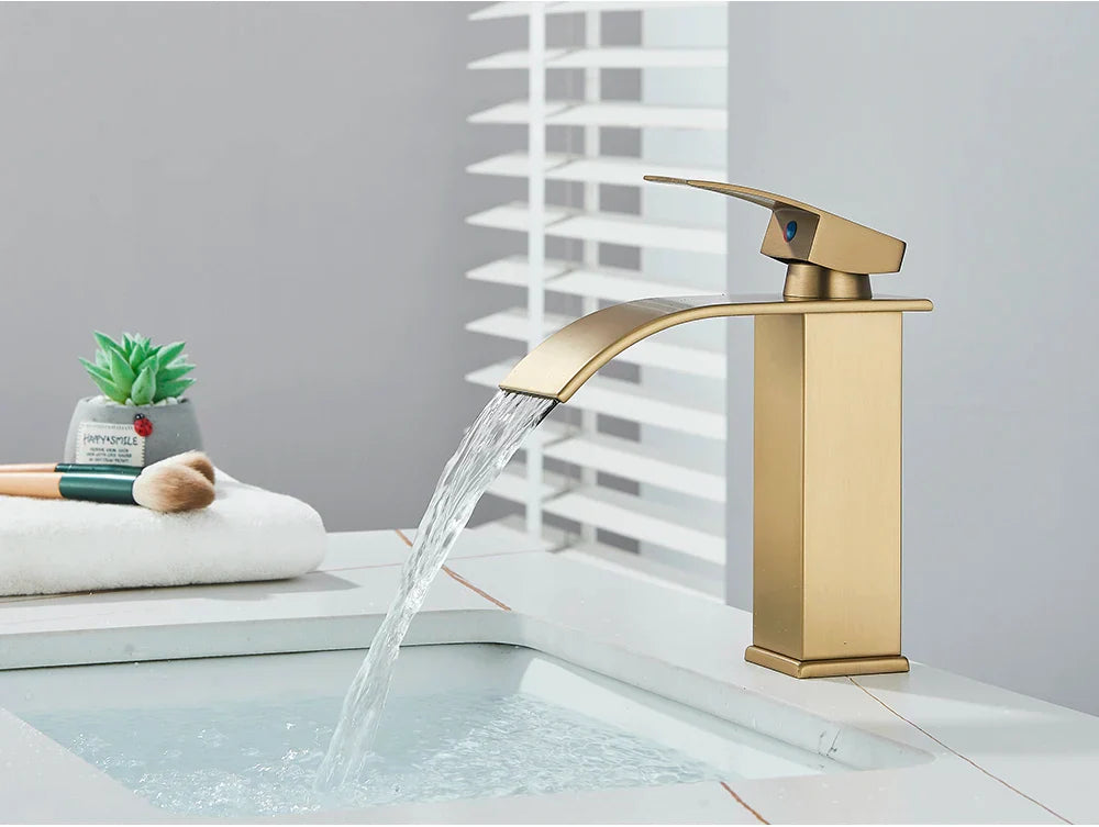 Gold-toned bathroom sink faucet brass deck mount with sleek modern design and stainless steel brushed metal finish