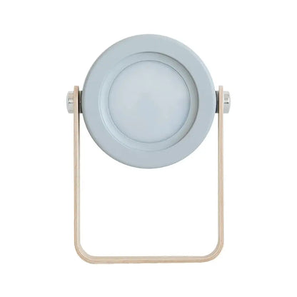 Light gray circular battery-operated wall sconce lantern with minimalist wooden frame and metallic accents