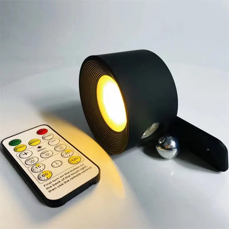 Black cylindrical battery operated wall sconce led table lamp with concentric ridges warm yellow light and remote control