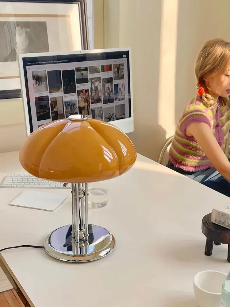 Vibrant orange glossy bauhaus medieval table lamp with amber glass and polished chrome base for bedroom atmosphere