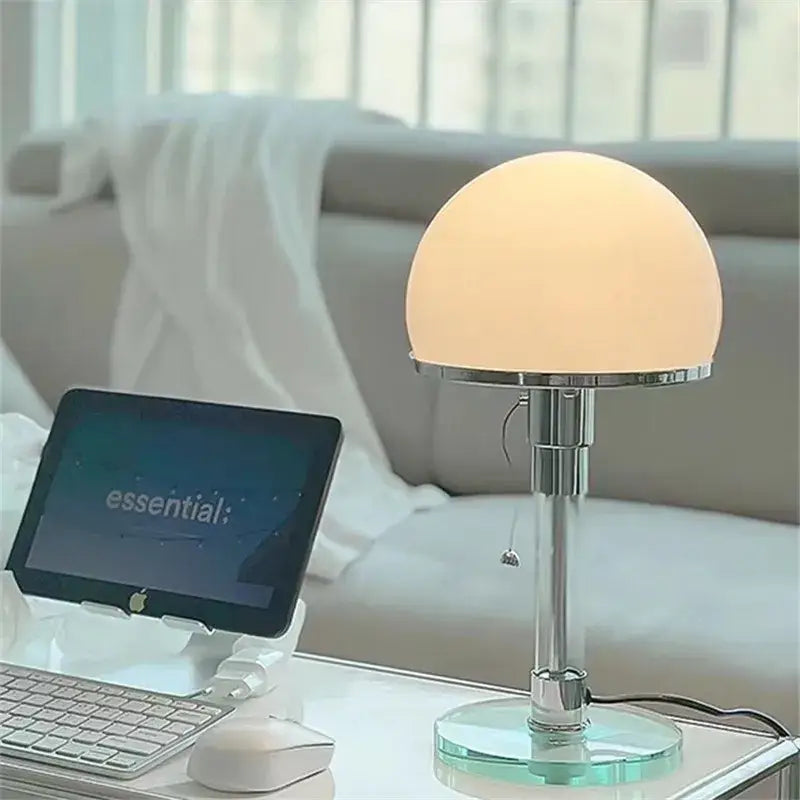 A bauhaus chrome and milk white glass table lamp with frosted opal dome shade and polished chrome stem on glass base
