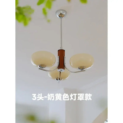 Cream-colored glass chandelier with a central wooden column and chrome accents for bauhaus art living room decor