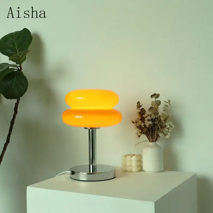 Vibrant orange bauhaus glass table lamp with double-donut shape and chrome base for bedroom lighting