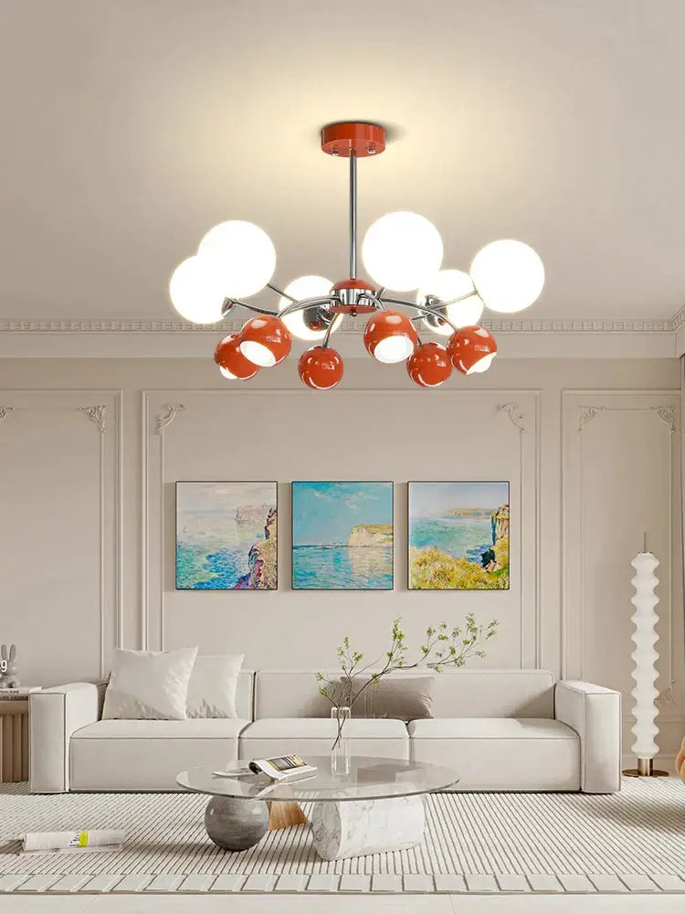 Modern lasha pendant light with chrome finish and spherical white and orange glass shades for dining room use