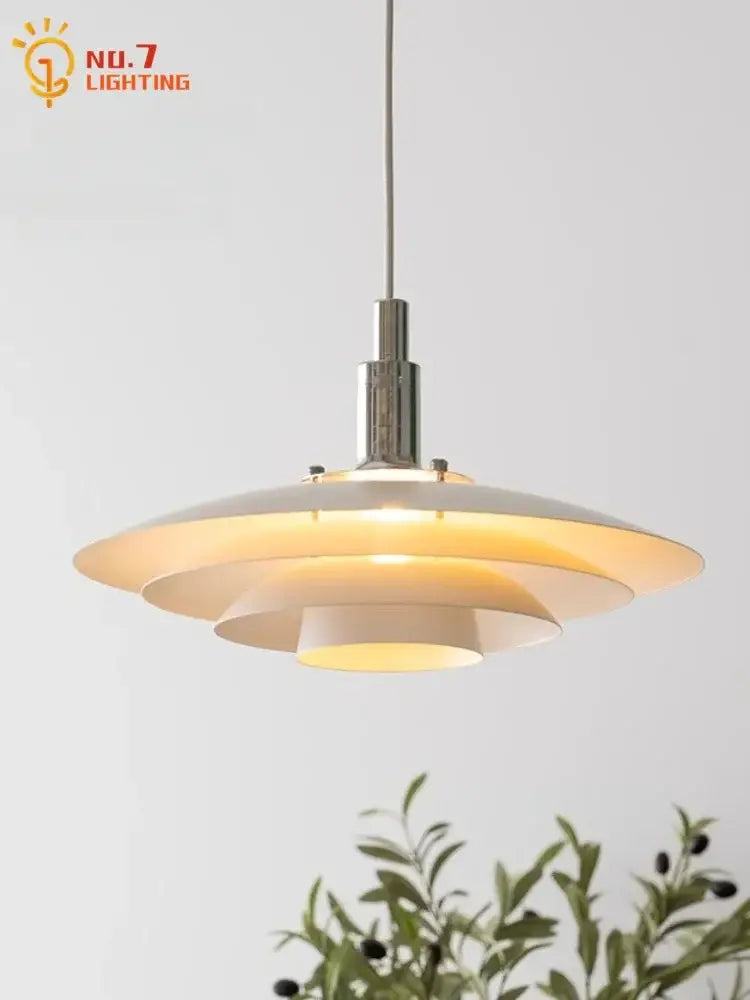 Modern bauhaus flying saucer pendant light with layered white shades and polished chrome fixture for dining room use