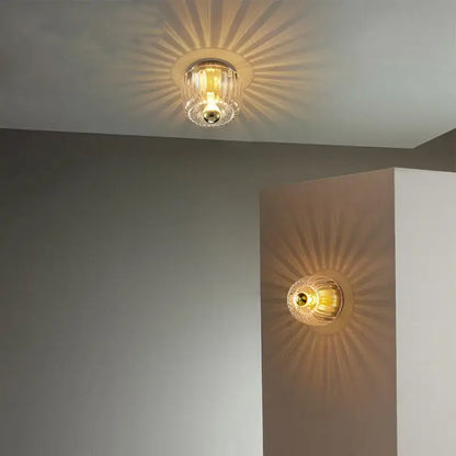 Bauhaus glass e14 wall lamp with clear ribbed glass ceiling and gold-toned metallic sunburst base for living room