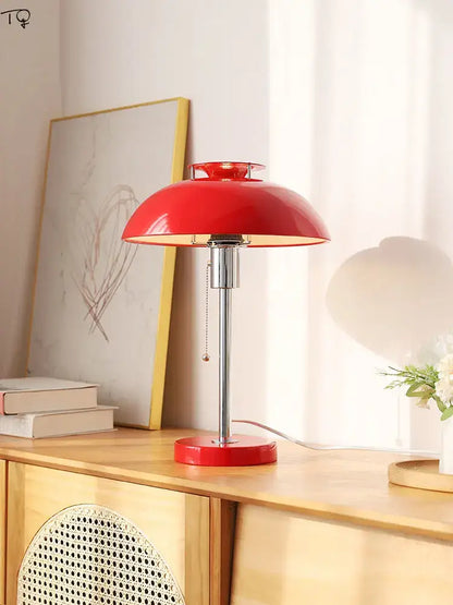 Vibrant red bauhaus led table lamp with glossy finish and chrome stem on circular base for bedroom use