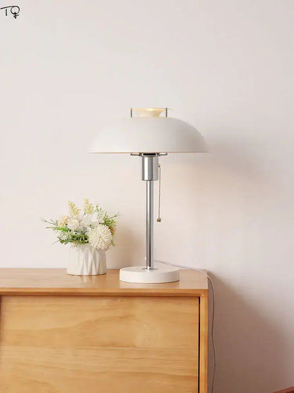 White ceramic bauhaus led table lamp with sleek chrome stem and pull-chain switch for bedroom use