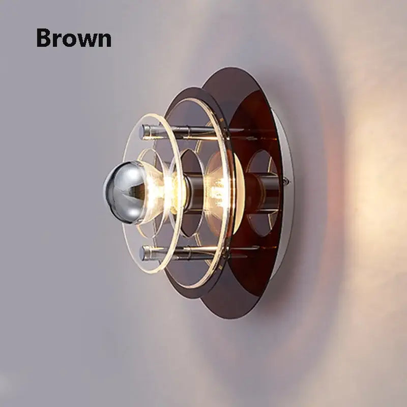 Brown bauhaus led wall light with layered circular glass and metal rings surrounding a central bulb for living room