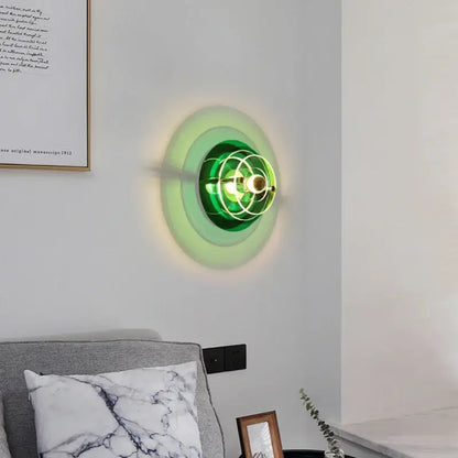Green glass bauhaus led wall sconce with circular layered design and brass accents for living room lighting