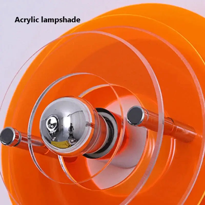 Vibrant orange acrylic bauhaus led wall light with clear circular rings and chrome bulb holder for living room use