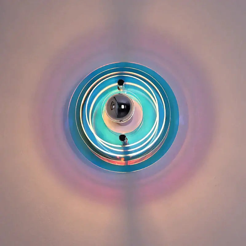 Bauhaus led wall light with vibrant teal blue concentric rings and central reflective sphere for living room use