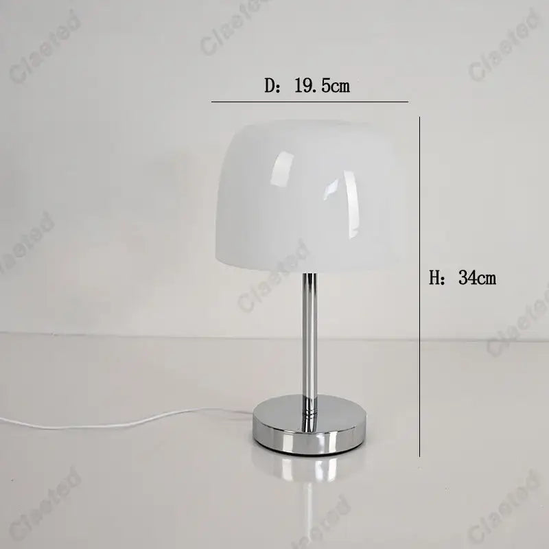 A sleek white glossy lampshade atop a polished chrome base on a bauhaus retro table lamp for modern interiors