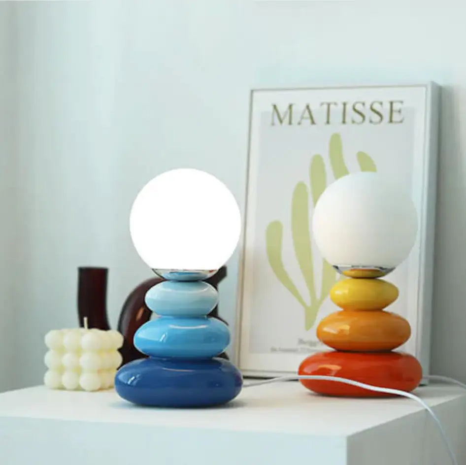 Blue and yellow stacked stone style bauhaus table lamps with frosted glass globes for modern decor lighting